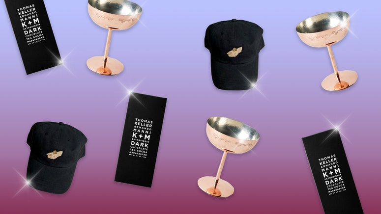 Luxury gifts: a hat with a caviar bump, copper cup, and fancy chocolate bar.